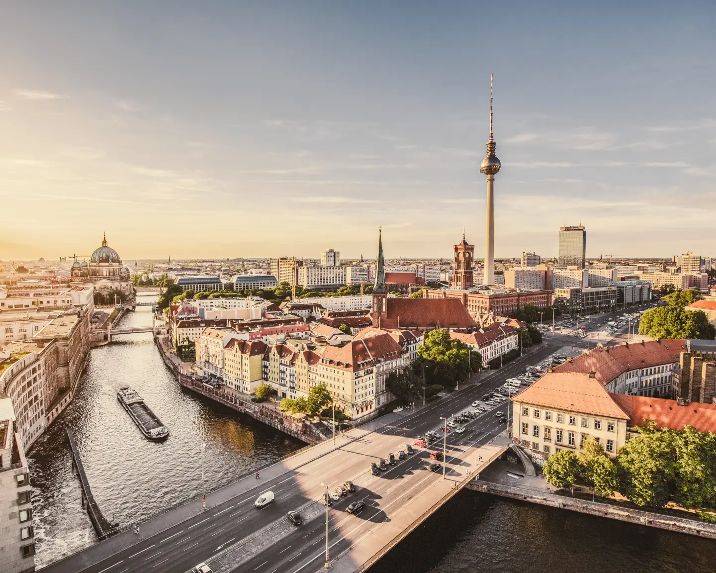 Aerial view of the Berlin skyline with the famous television tower and the Spree in the beautiful evening light at sunset.